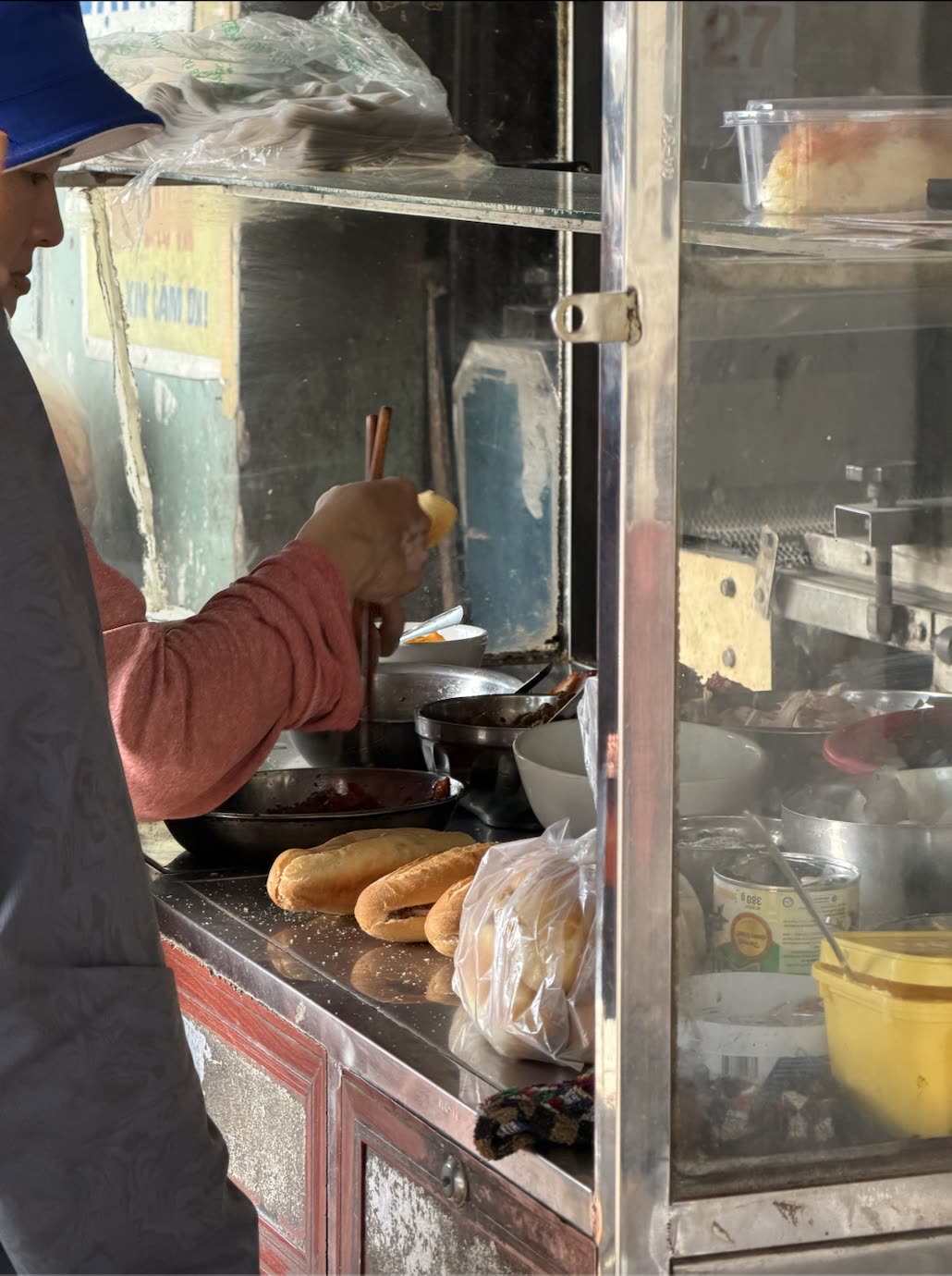 Sokak tezgâhında bánh mì hazırlayan satıcı